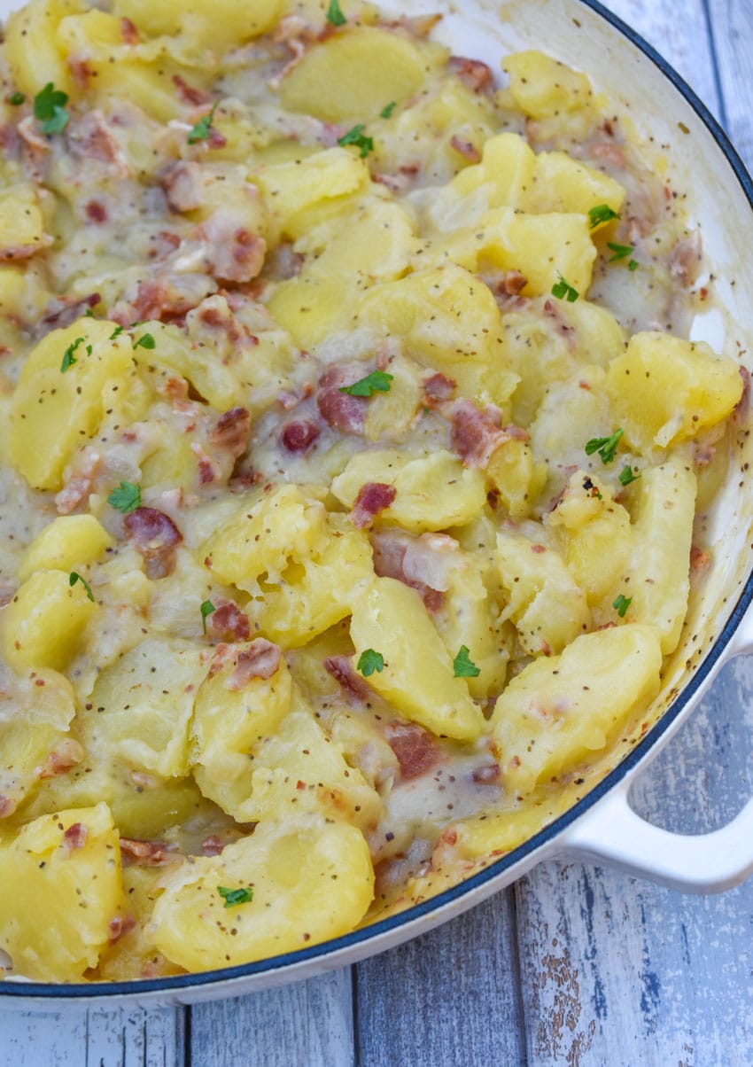 warm german potato salad in a large white skillet