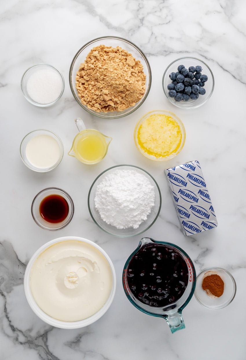 an overhead image showing the measured ingredients needed to make a batch of blueberry cheesecake jars
