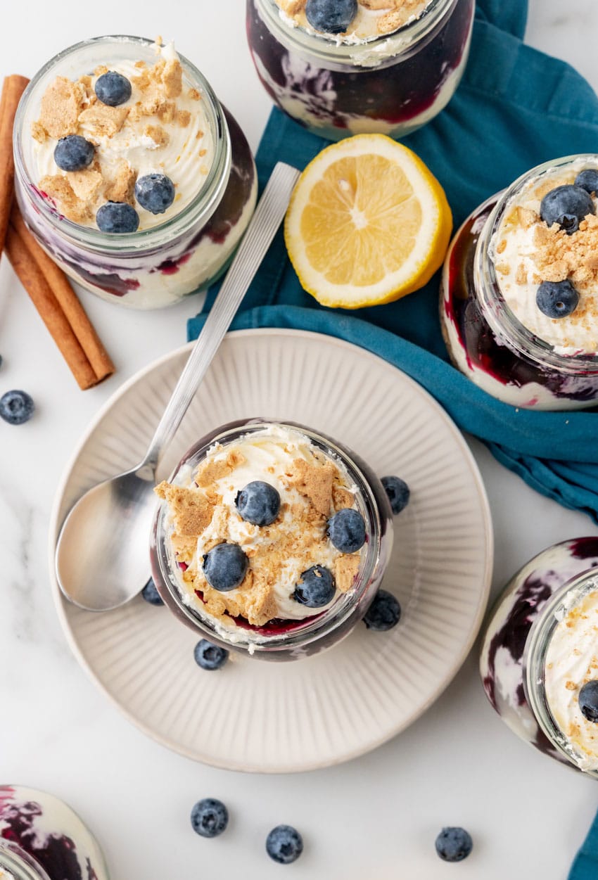 blueberry cheesecake jars on white plates