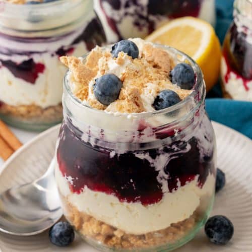 blueberry cheesecake jars on white plates