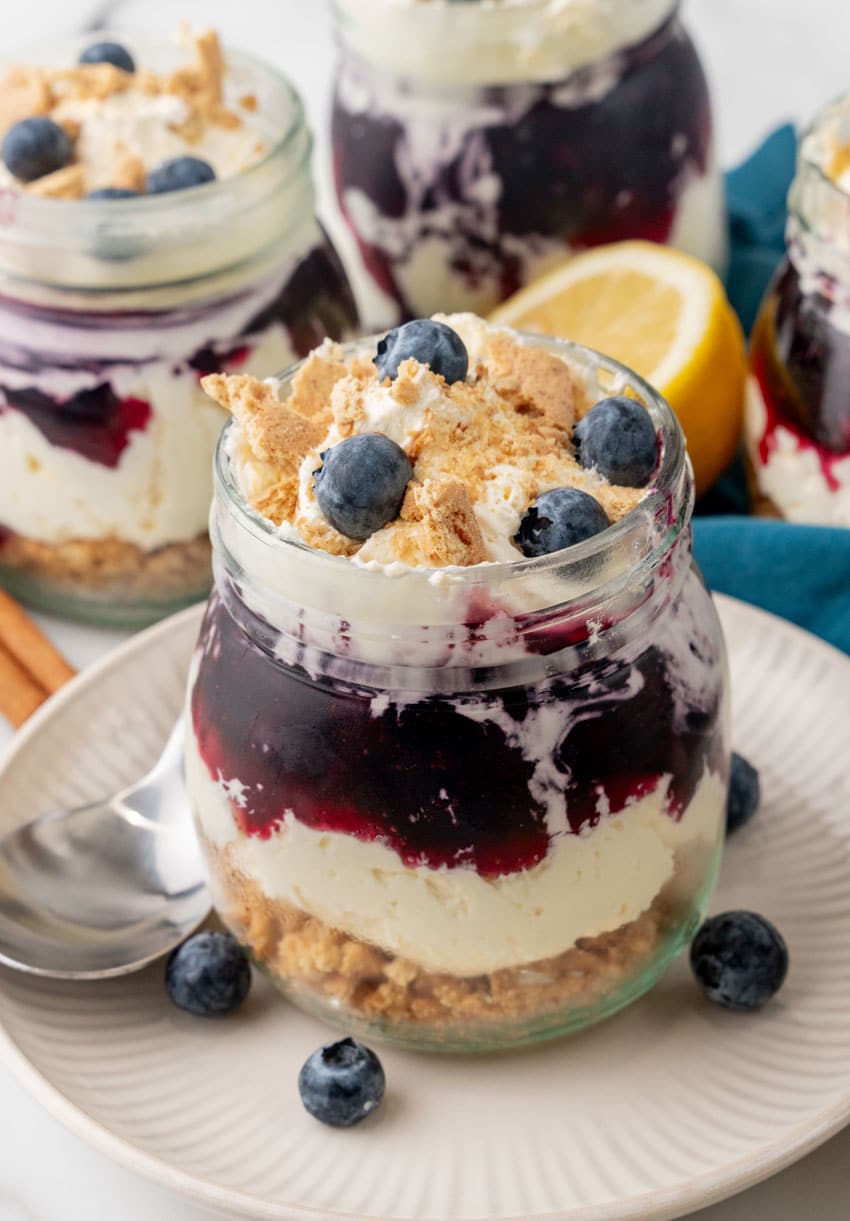 blueberry cheesecake jars on white plates