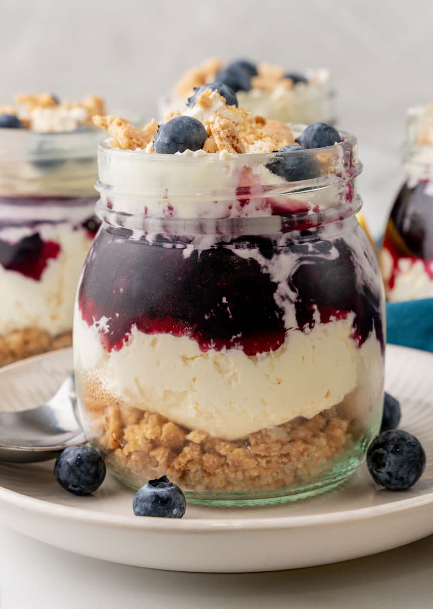 blueberry cheesecake jars on white plates