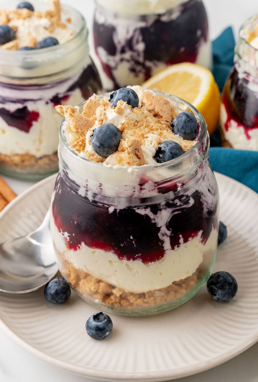 blueberry cheesecake jars on white plates