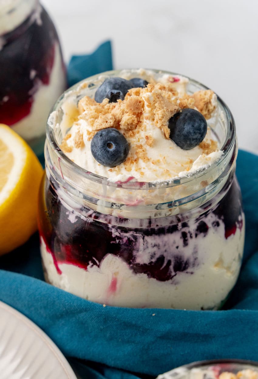 a close up of a blueberry cheesecake jar