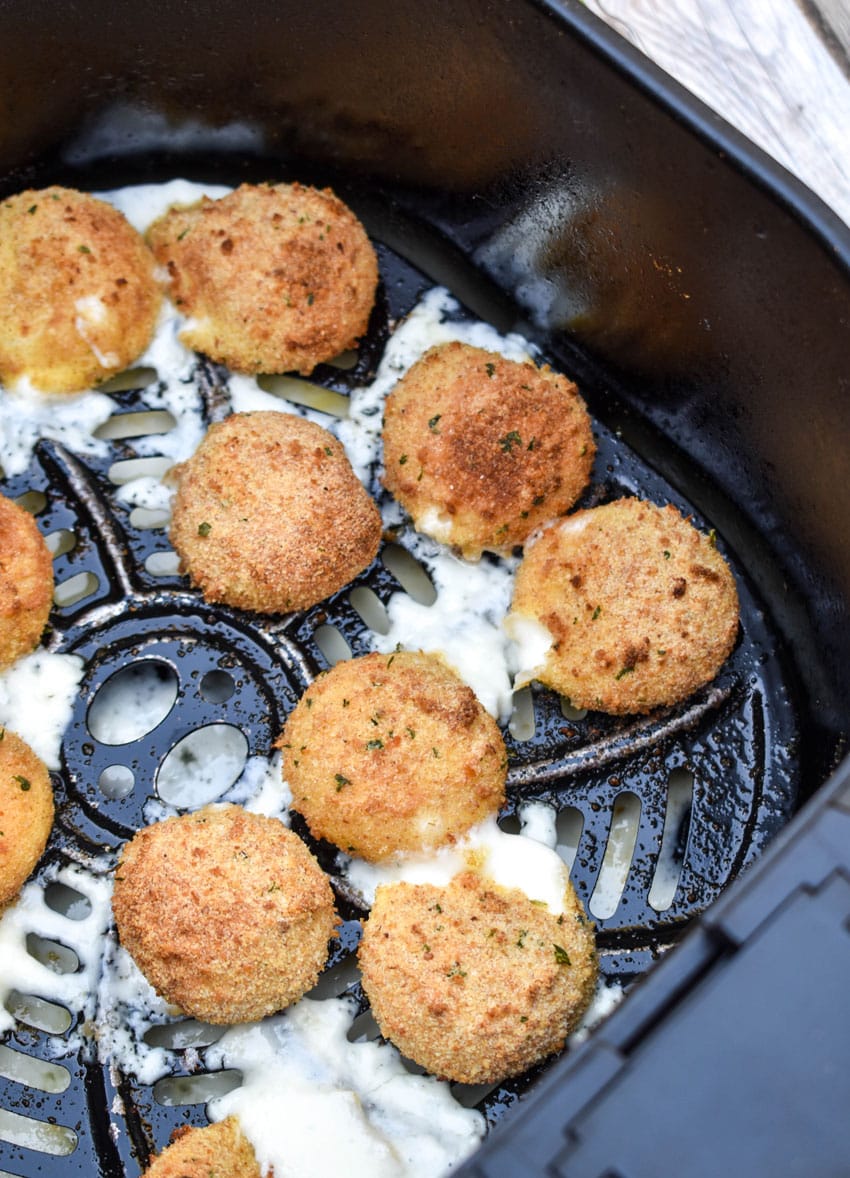 fried babybel cheese in the basket of an airfryer