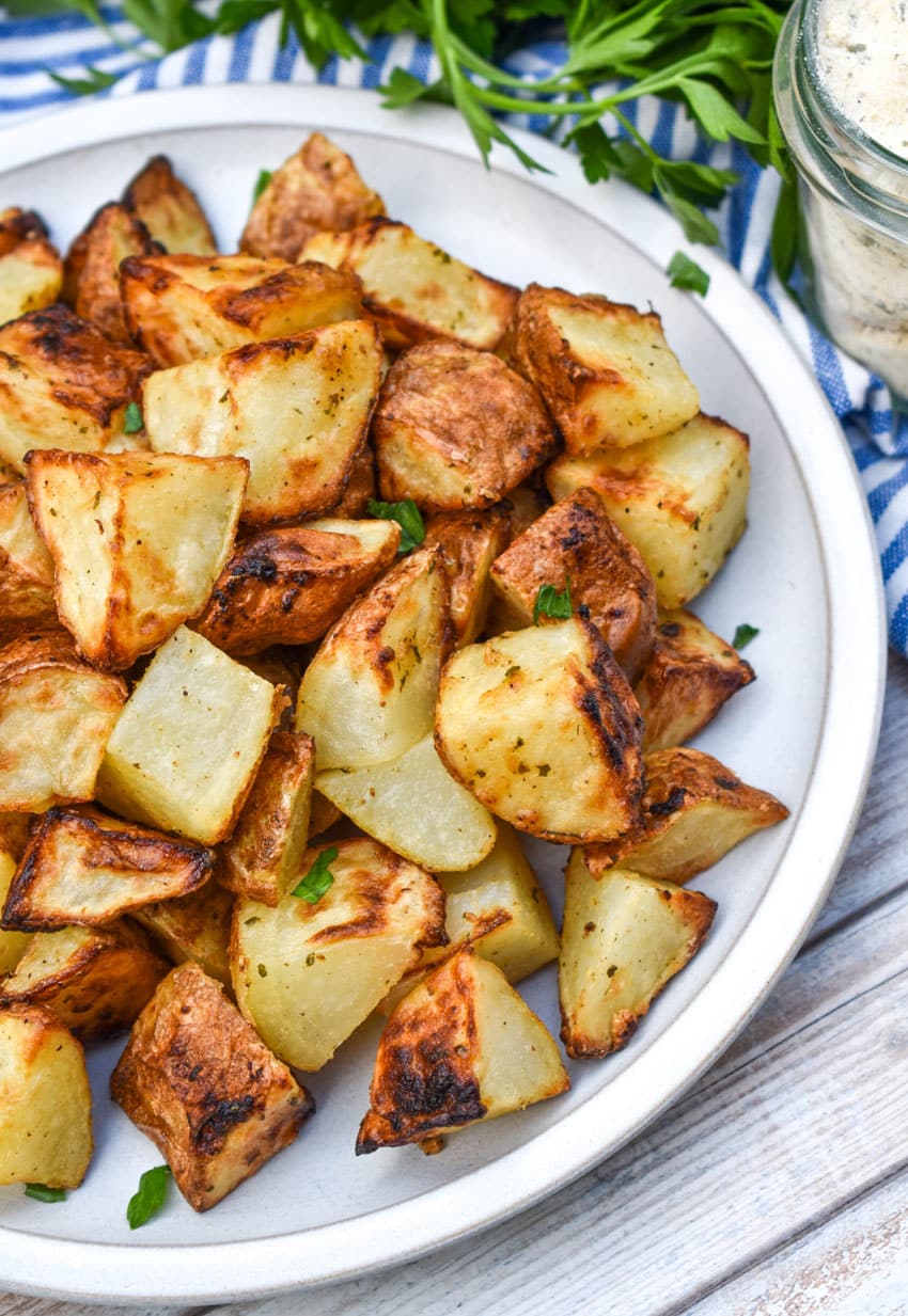 air fried crispy ranch potatoes on a white plate