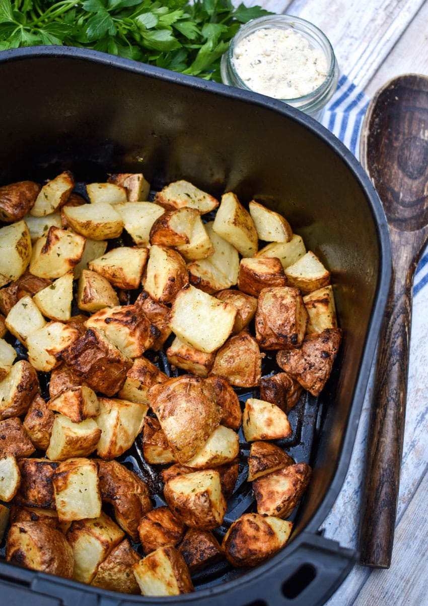 crispy ranch potatoes in the black basket of an air fryer