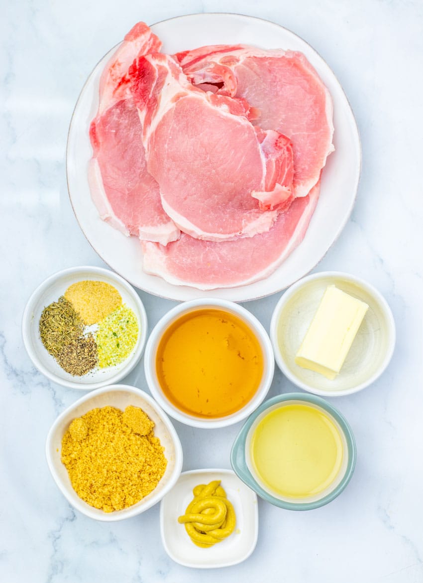 an overhead image showing the measured ingredients needed to make a batch of apple cider glazed pork chops