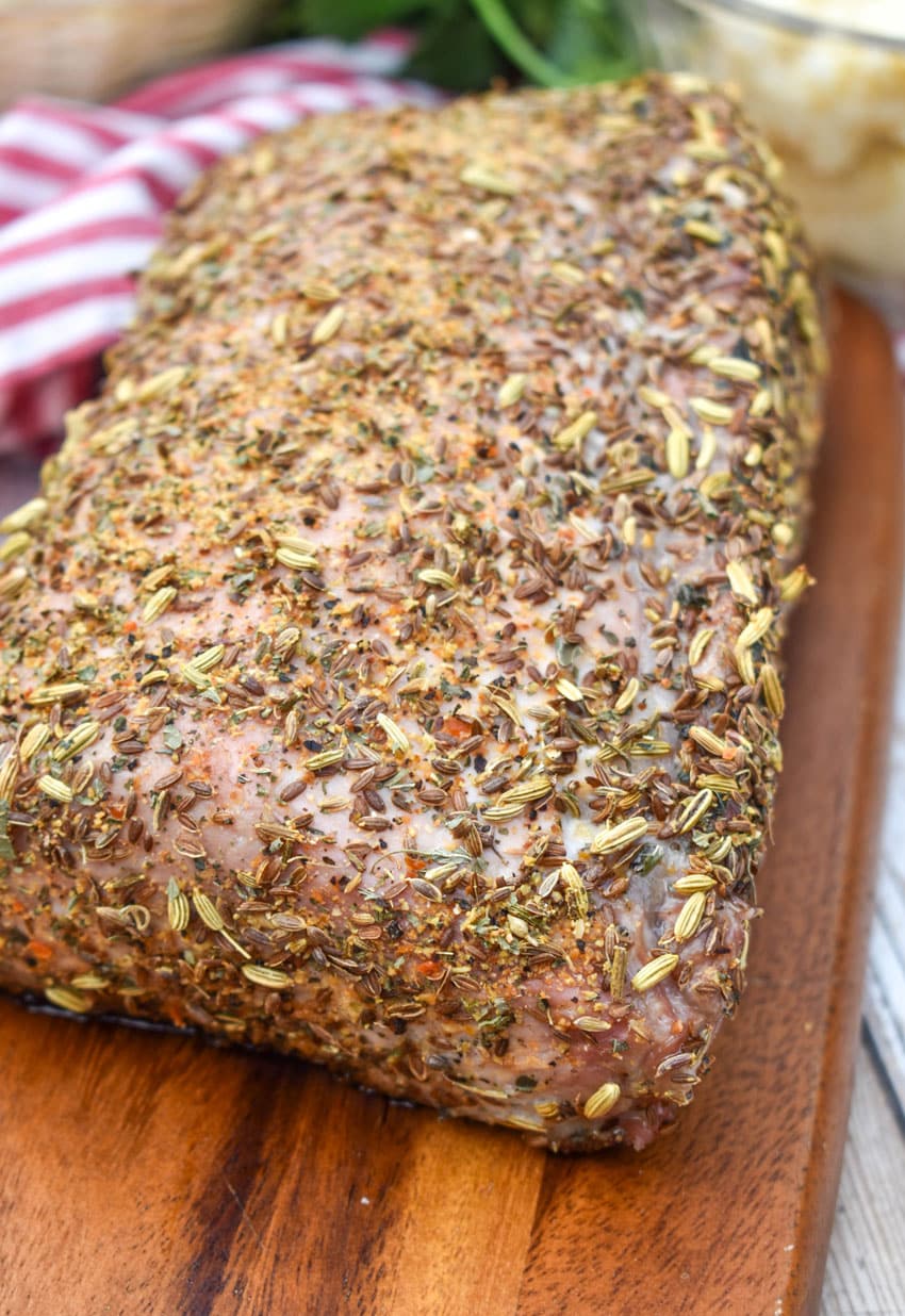 a close up of Italian porchetta on a wooden cutting board