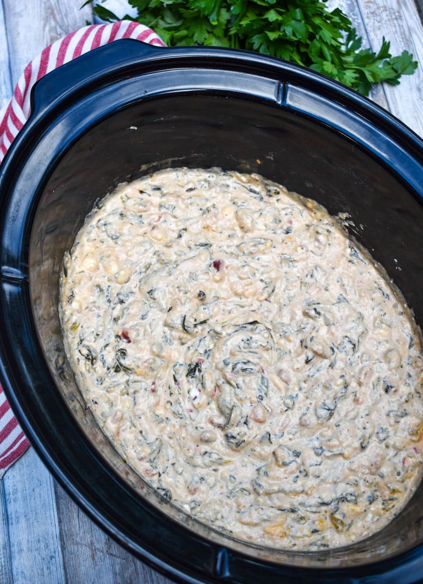 Mexican Spinach Dip (Slow Cooker Recipe) mexican spinach dip in the black bowl of a slow cooker