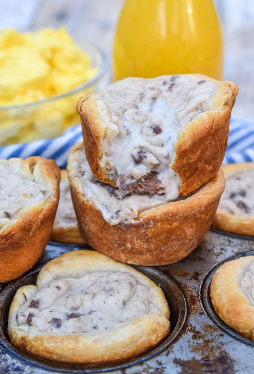 sausage gravy biscuit cups in a metal muffin tin