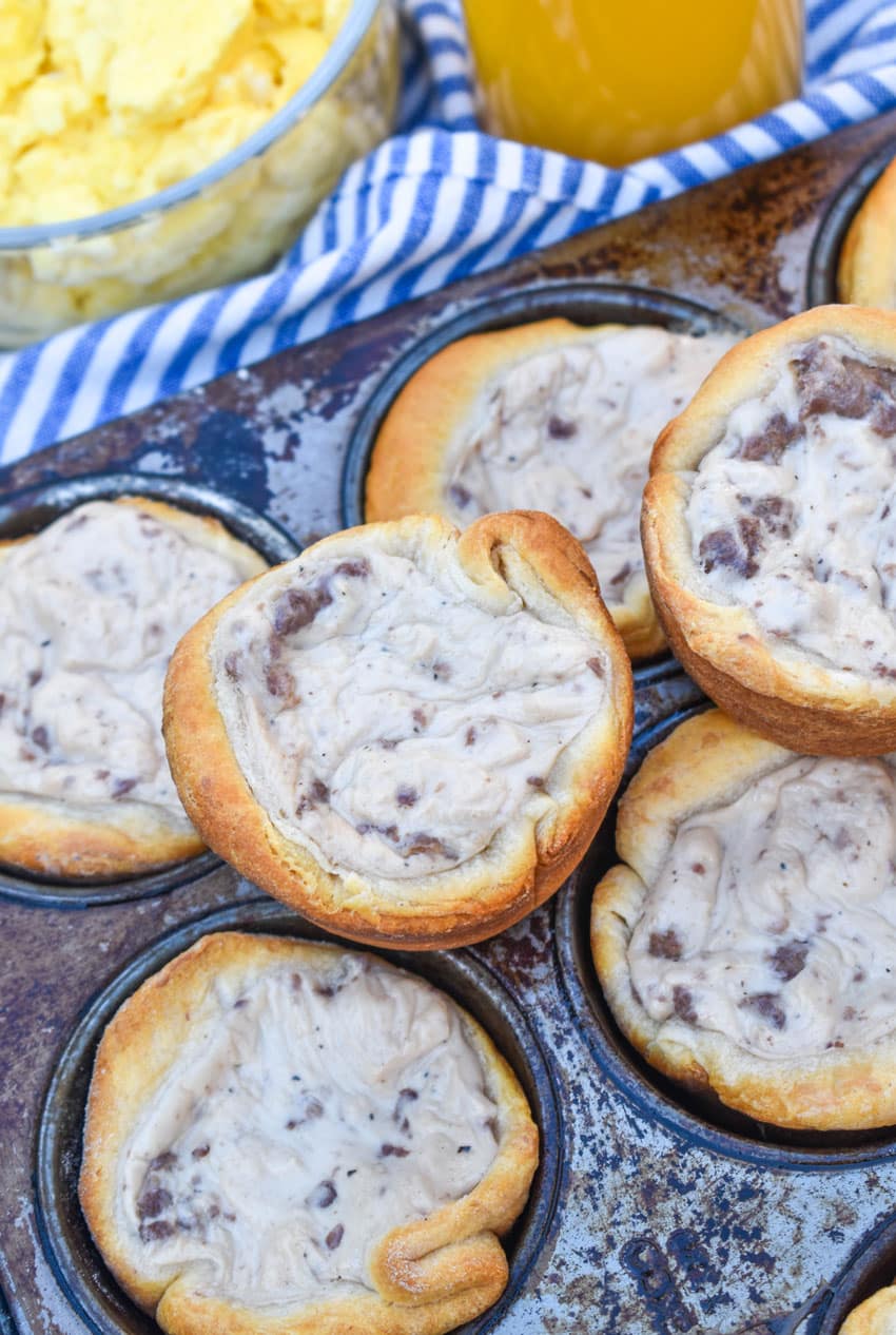 sausage gravy biscuit cups in a metal muffin tin