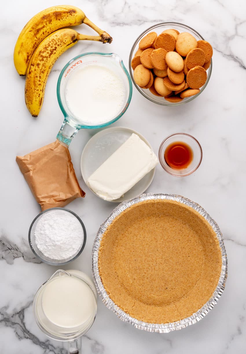 an overhead image showing the measured ingredients needed to make a banana cream pie
