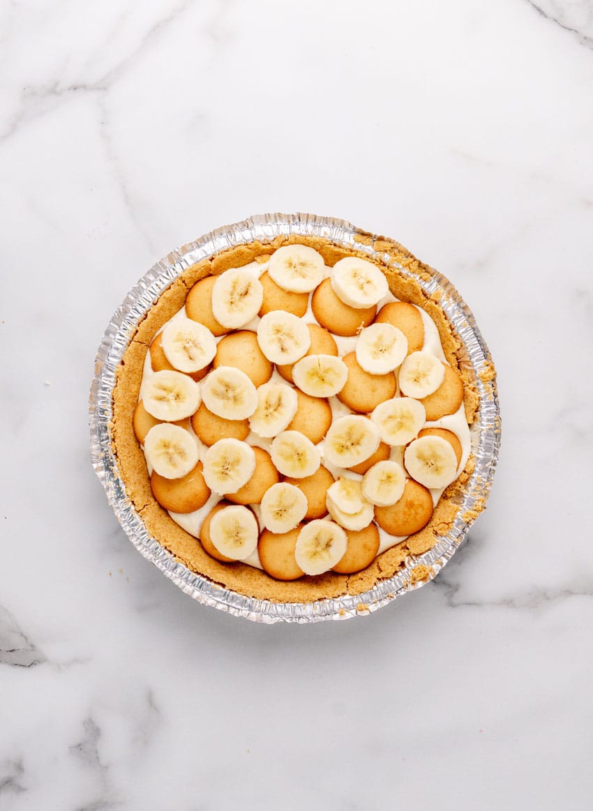 banana cream pie layers in a graham cracker pie crust