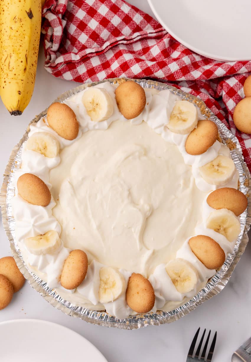 a banana cream pie on a marble countertop