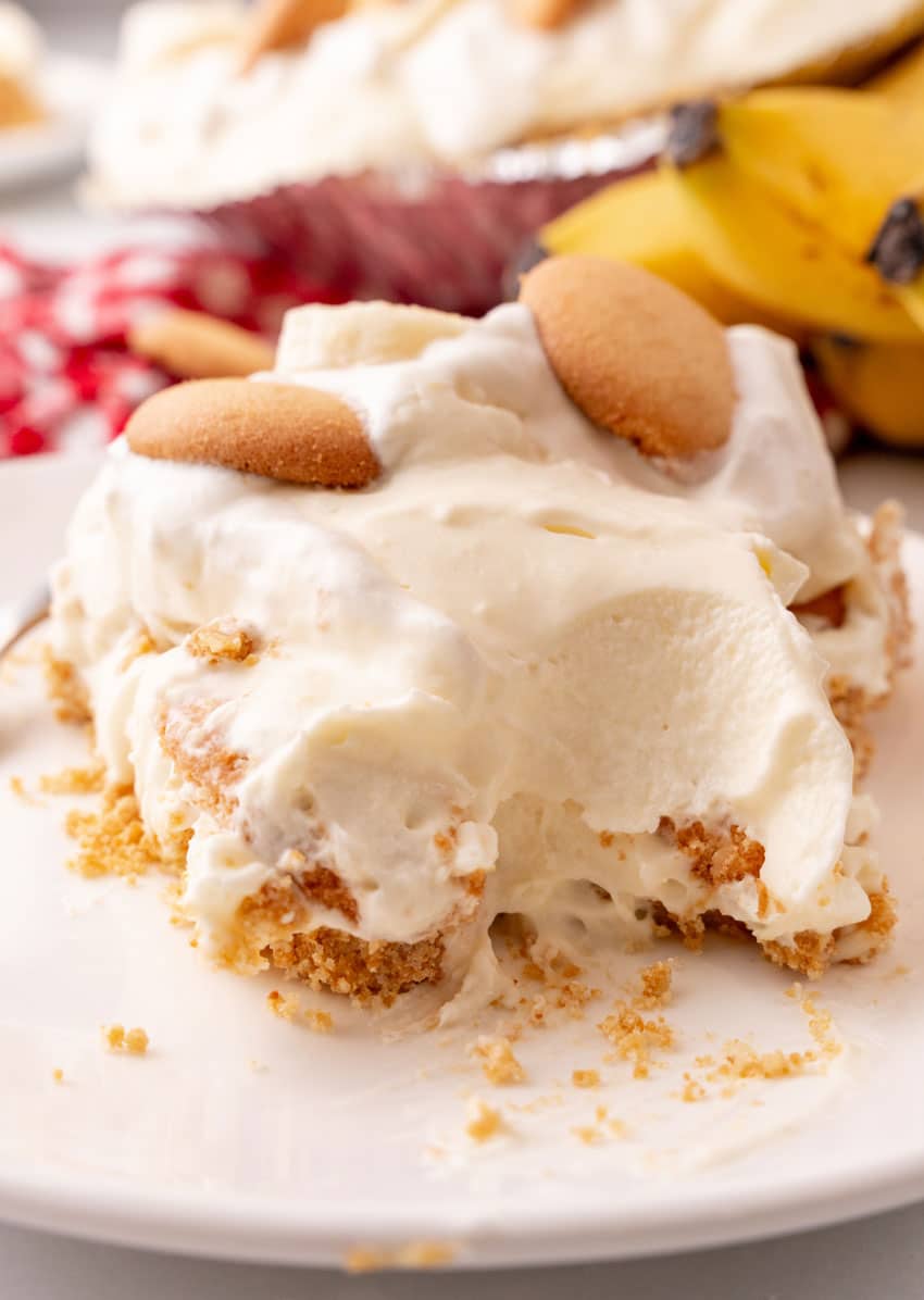 a slice of banana cream pie on a white dessert plate