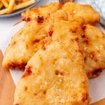 slices of pizza crunch on a parchment paper lined wooden cutting board