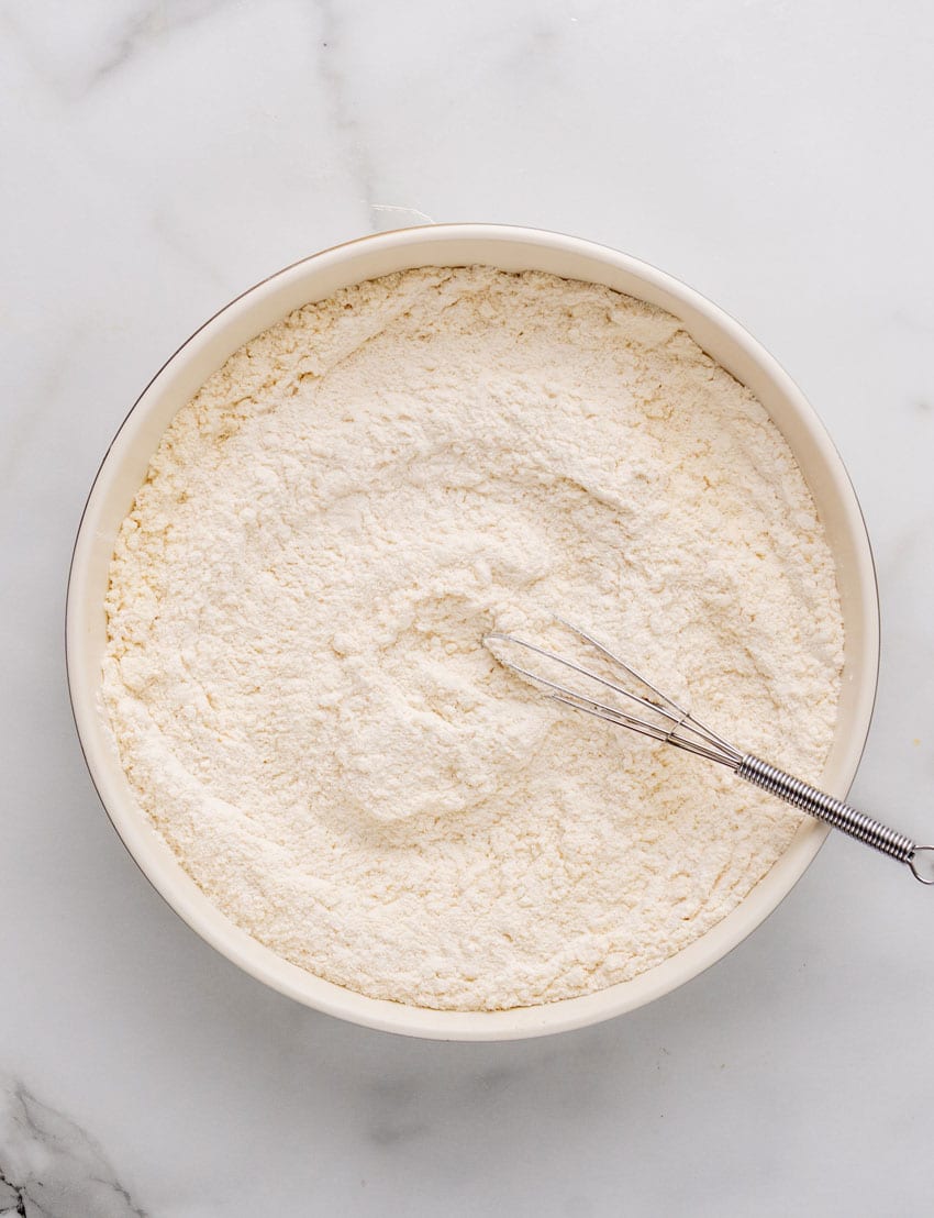 dry ingredients for a homemade beer batter in a large white mixing bowl