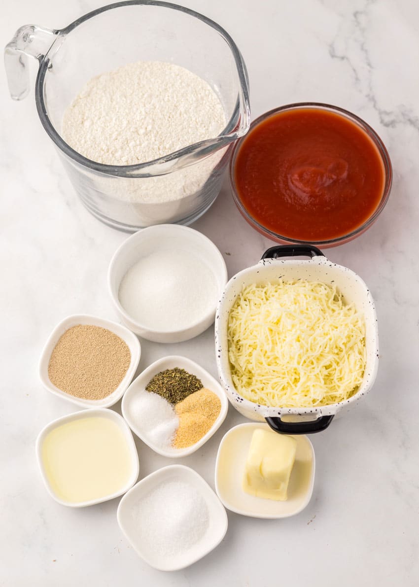 an overhead image showing the measured ingredients needed to make a copycat pizza hut personal pan pizza