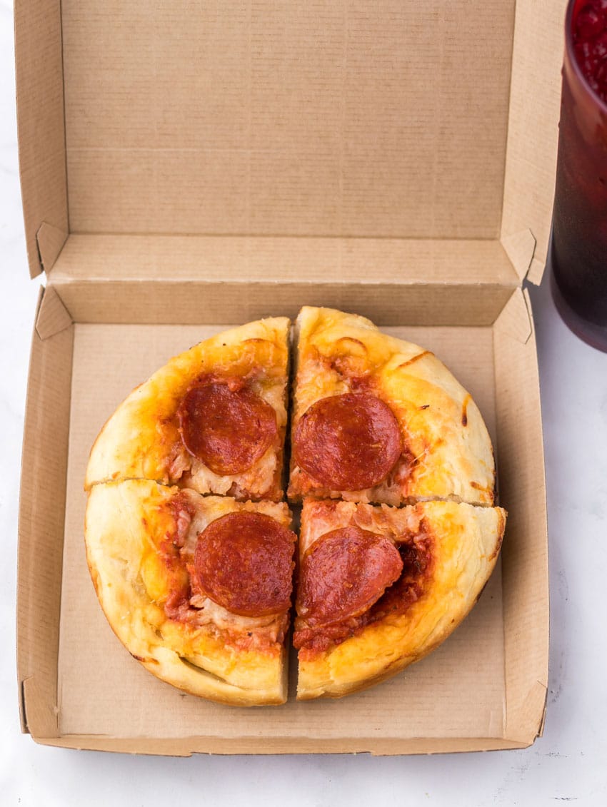 a homemade copycat pizza hut personal pan pizza in a small cardboard pizza box