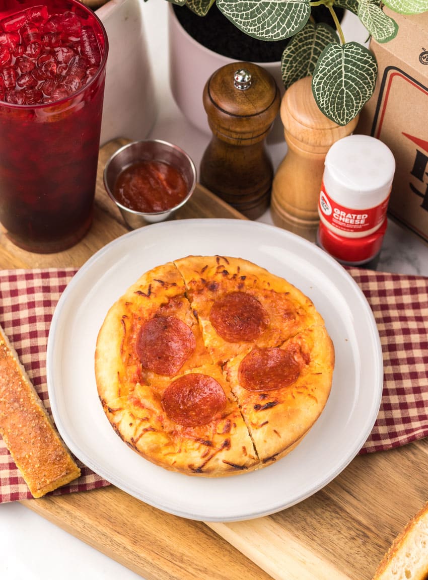 a copycat pizza hut personal pan pizza on a white plate