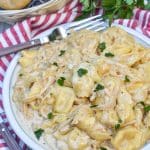 creamy french onion tortellini on a white plate