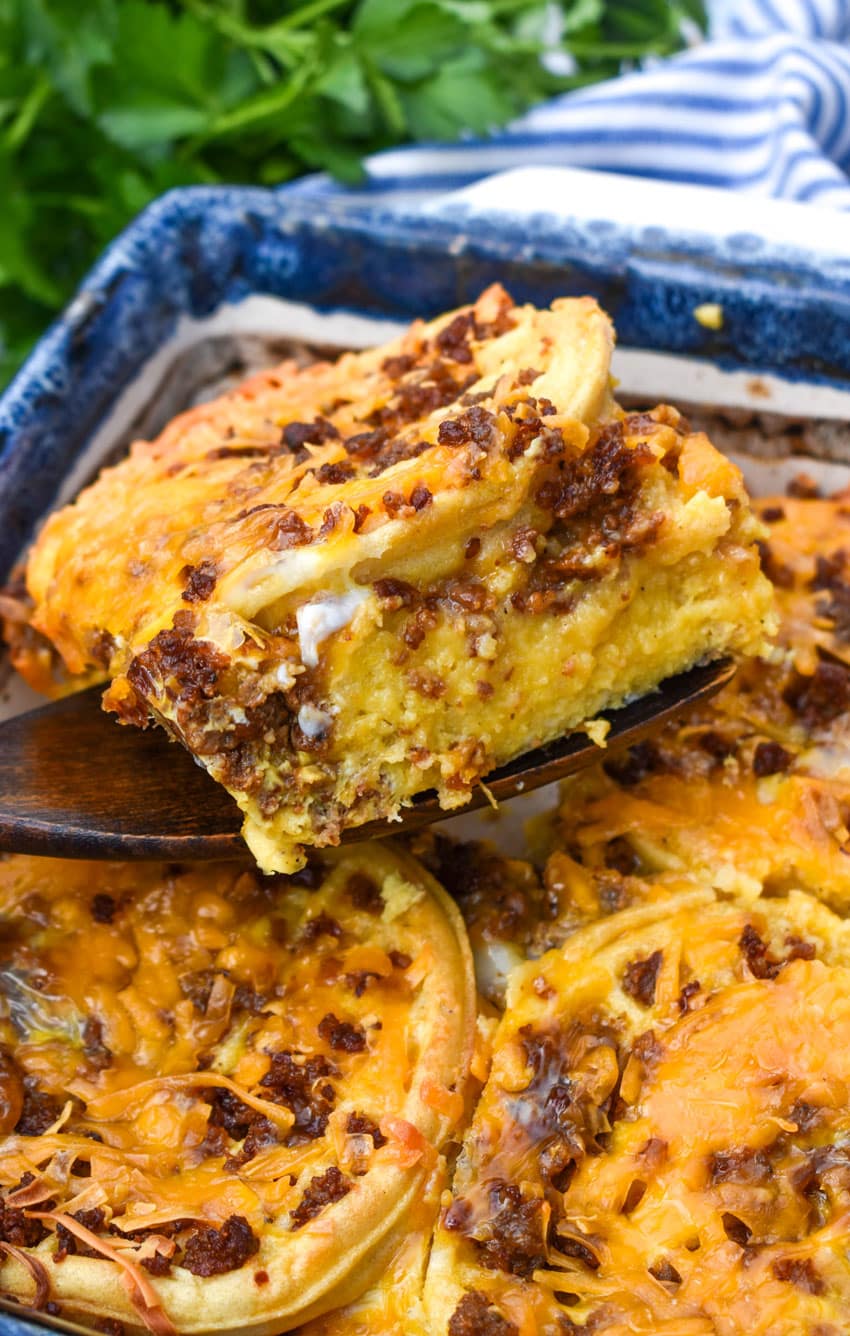 a wooden spatula lifting up a slice of frozen waffle bread pudding