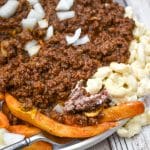 a fork digging into a homemade new york style garbage plate