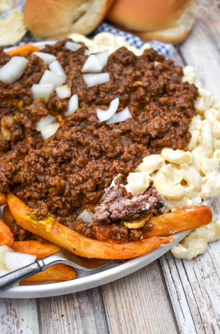 a fork digging into a homemade new york style garbage plate