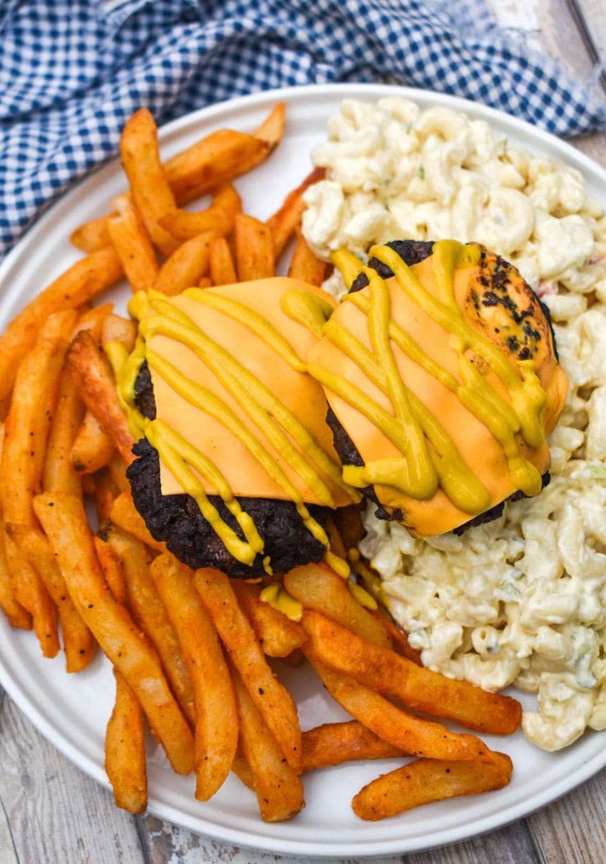 an overhead image showing a homemade new york style garbage plate on a wooden picnic table