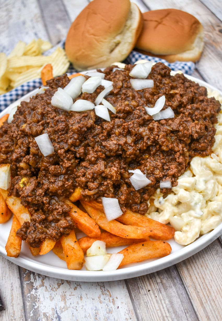 french fries and macaroni salad topped with hot dog chili on a white plate