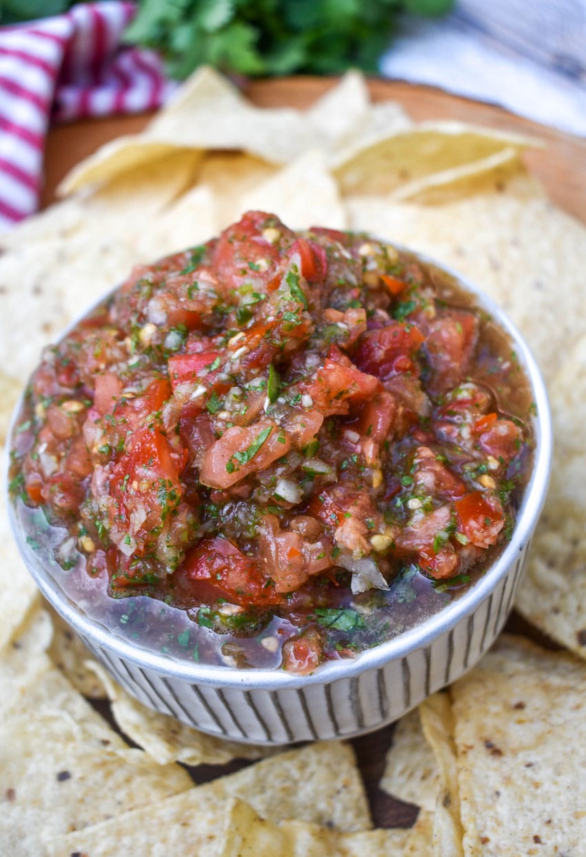 easy salsa fresca in a small white bowl surrounded by tortilla chips