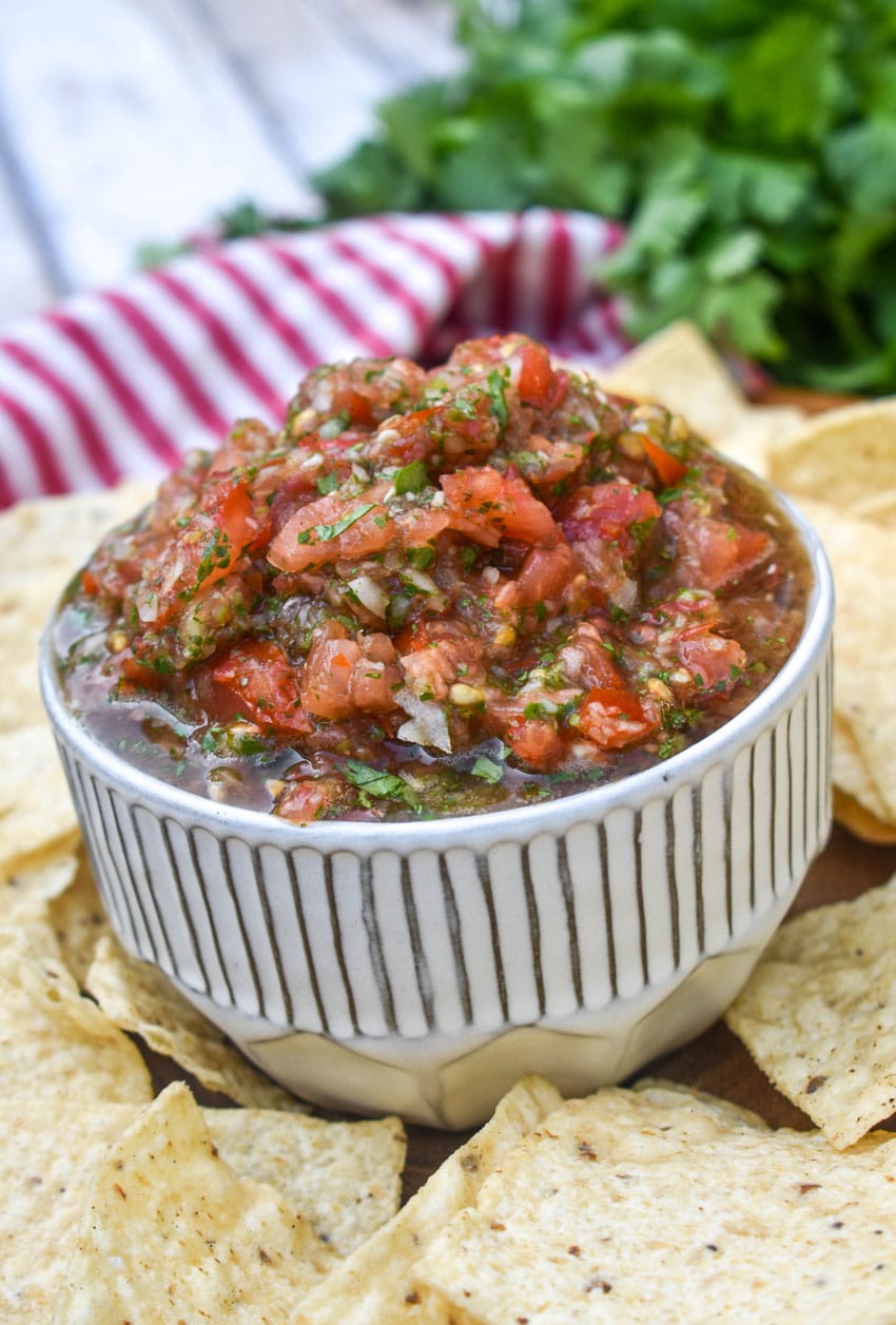 easy salsa fresca in a small white bowl surrounded by tortilla chips