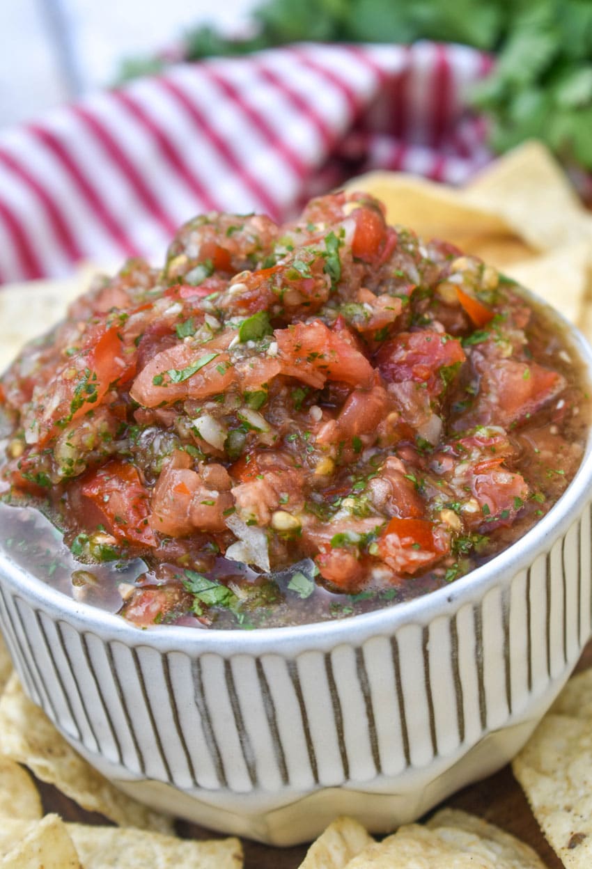 easy salsa fresca in a small white bowl surrounded by tortilla chips