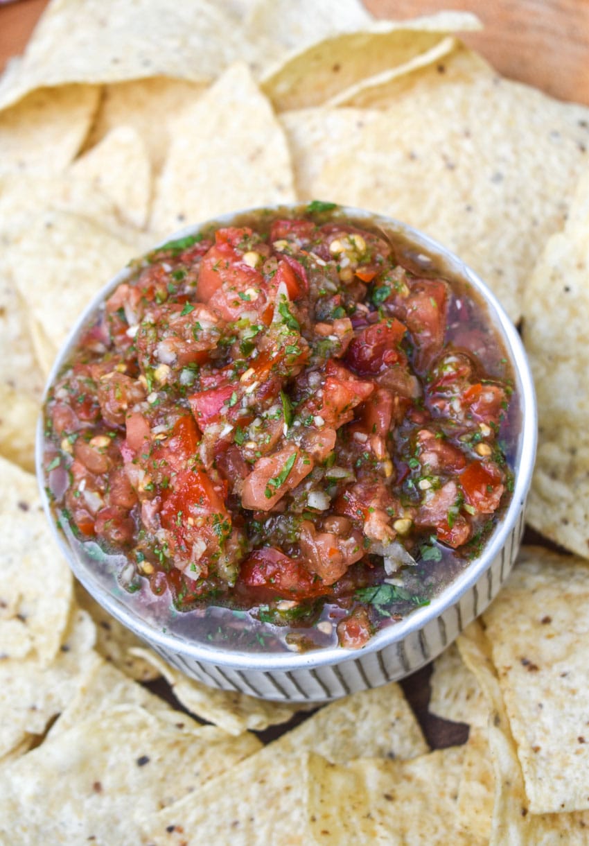 easy salsa fresca in a small white bowl surrounded by tortilla chips
