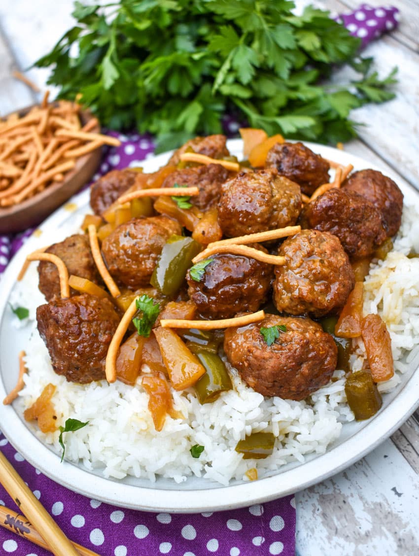 Sweet And Sour Meatballs (Slow Cooker Recipe) slow cooker sweet and sour meatballs over steamed white rice on a white plate
