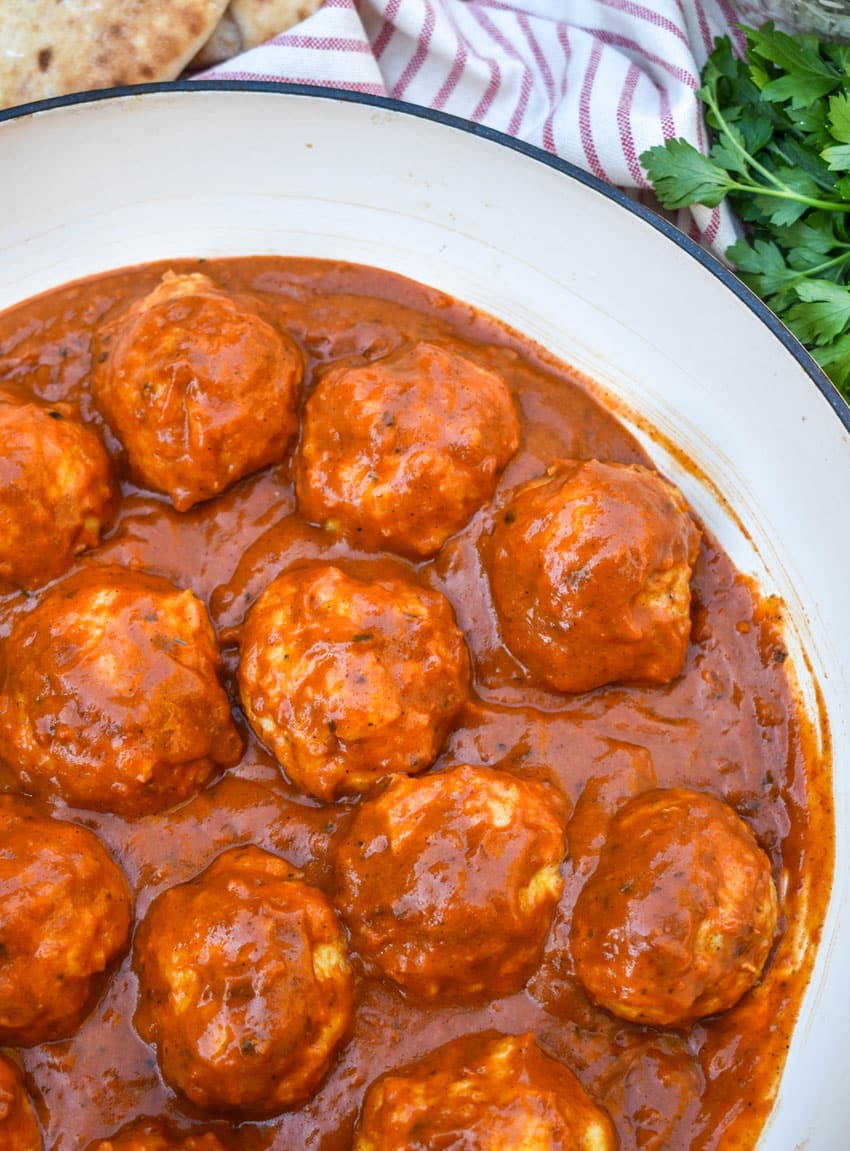 butter chicken meatballs in a large cast iron skillet
