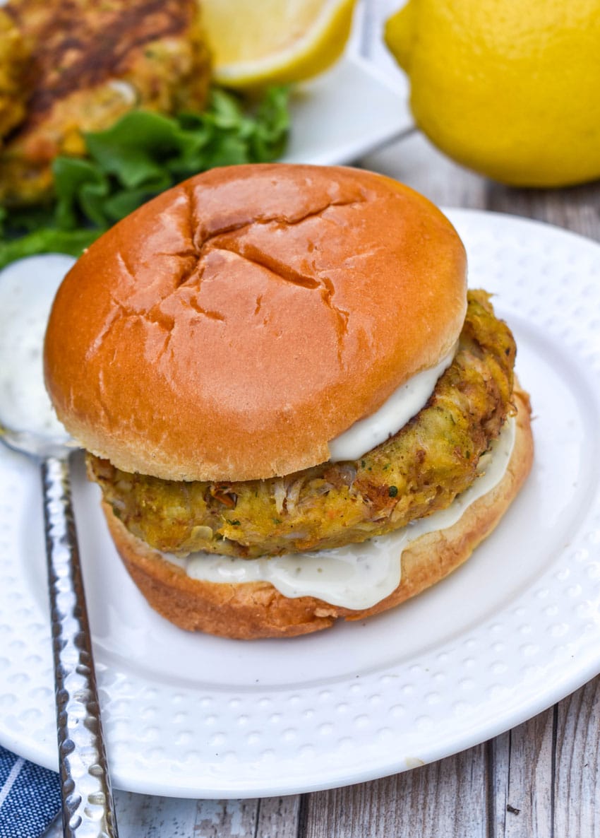 a crab cake sandwich on a small white plate