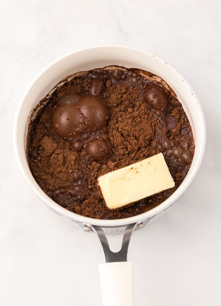 homemade dr pepper chocolate sauce ingredients in a small white pot