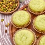 pistachio pudding muffins on a wooden cake stand
