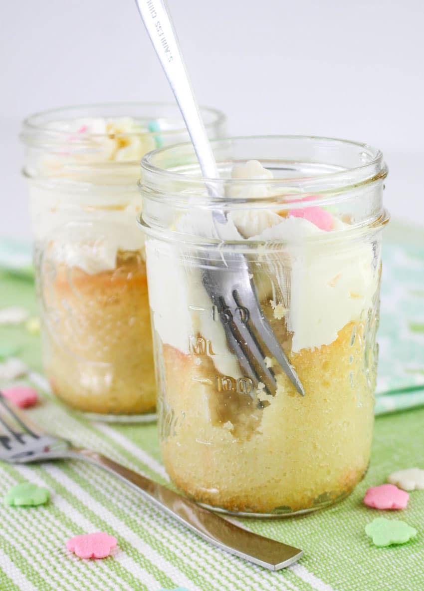 a silver fork scooping pieces of a homemade mini cake out of a small glass jar