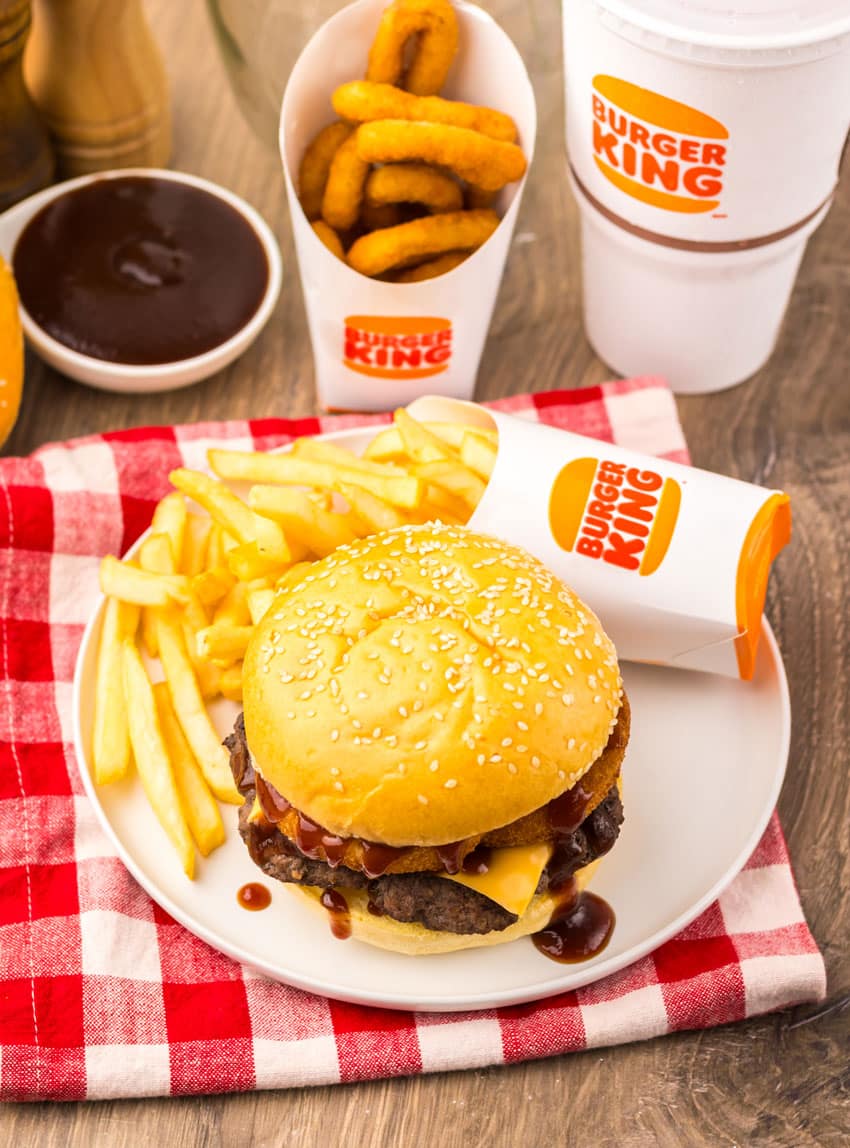 copycat burger king rodeo burger on a small white plate with french fries on the side