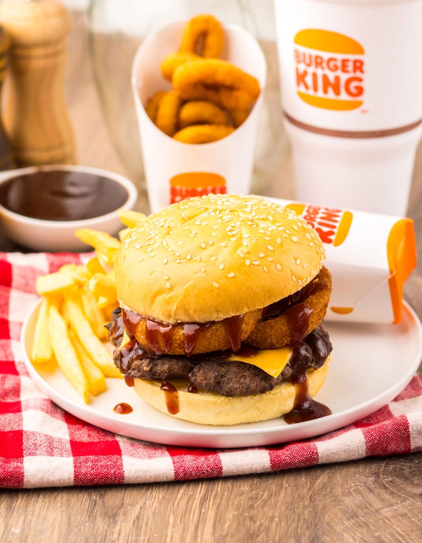 copycat burger king rodeo burger on a small white plate with french fries on the side