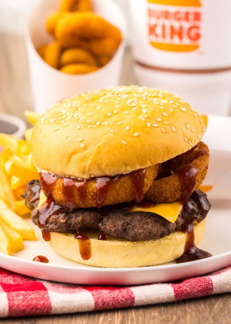 copycat burger king rodeo burger on a small white plate with french fries on the side