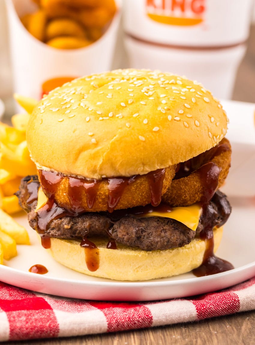 copycat burger king rodeo burger on a small white plate with french fries on the side