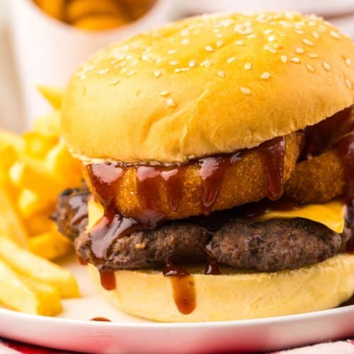 copycat burger king rodeo burger on a small white plate with french fries on the side