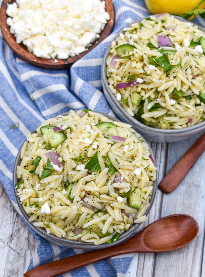 cucumber lemon orzo salad in two small gray bowls