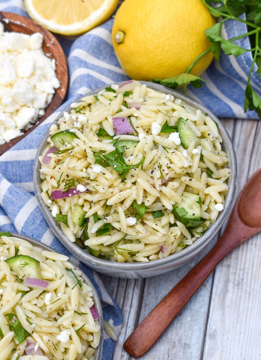 cucumber lemon orzo salad in two small gray bowls