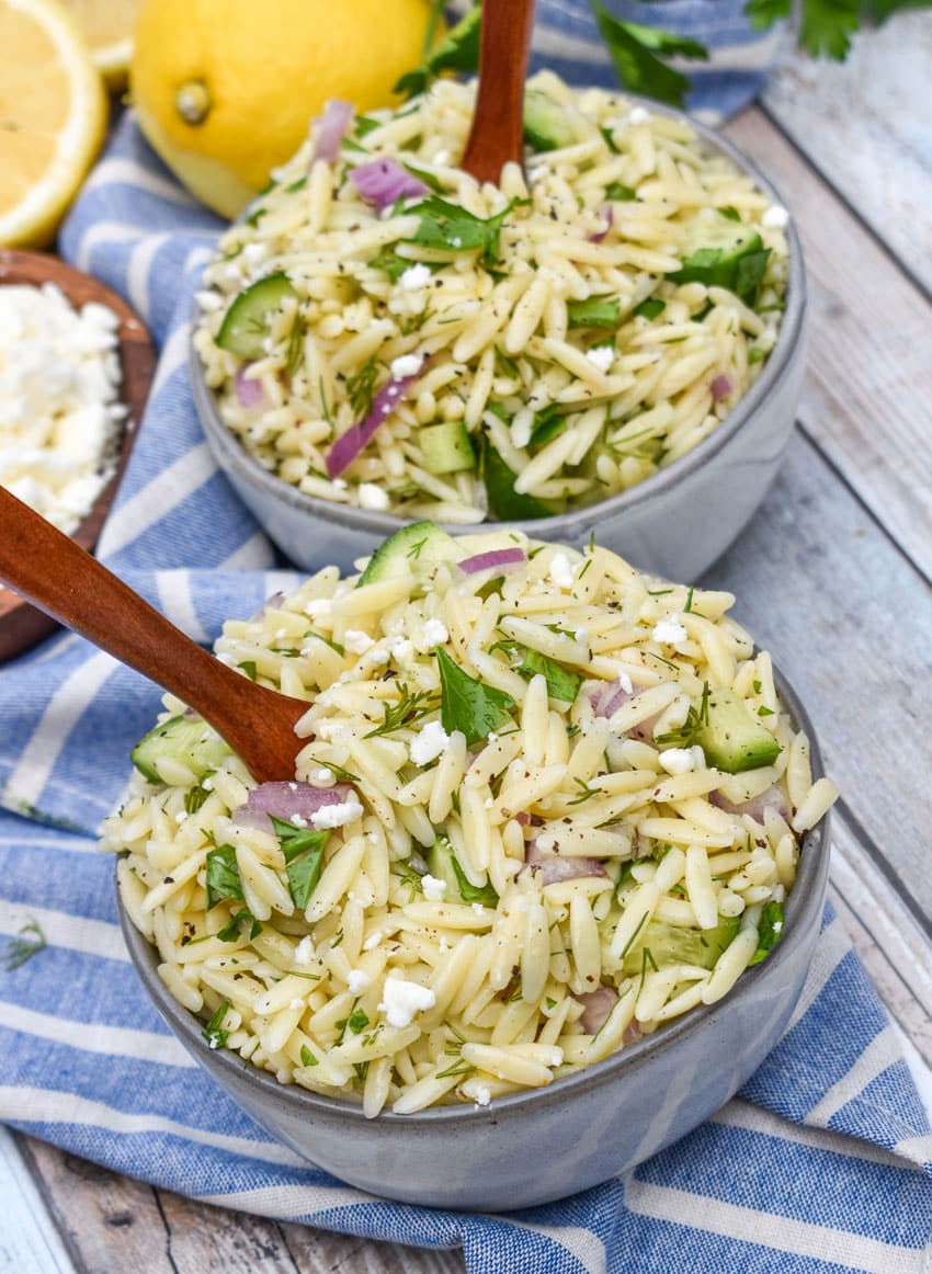 cucumber lemon orzo salad in two small gray bowls