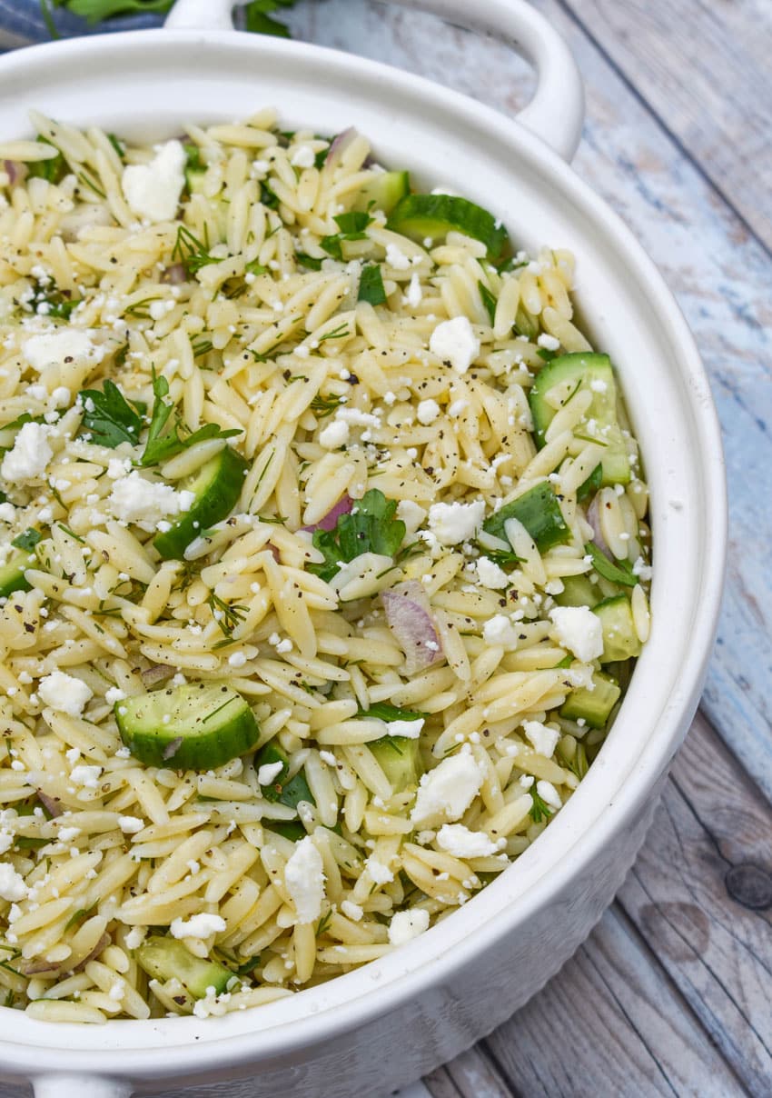 cucumber lemon orzo salad in a white serving bowl